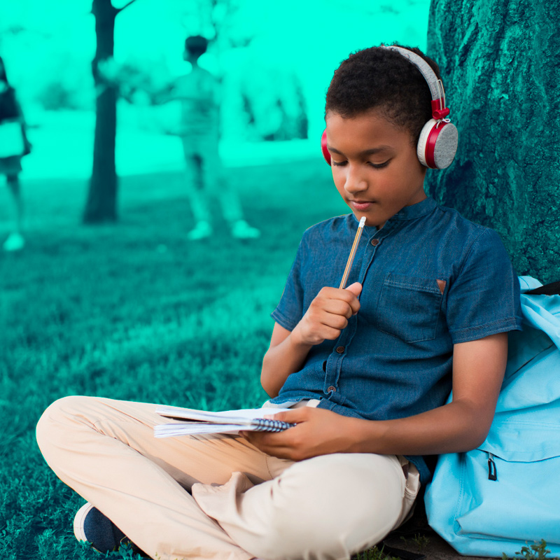 Boy reading in a park